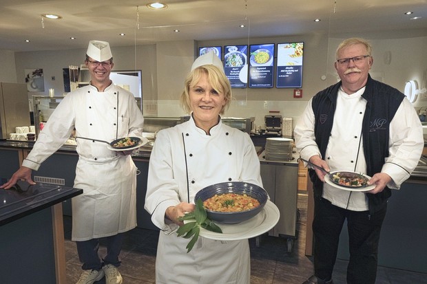 Drei Mitarbeitende der Küche präsentieren nachhaltige Gerichte in der Klinik-Kantine.